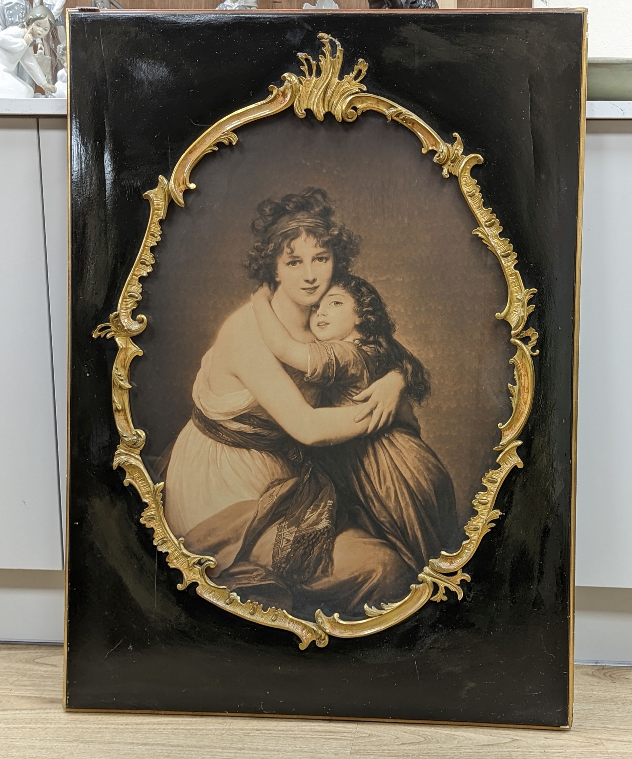 A sepia print of a mother and child within parcel gilt ebonised frame, overall 103 x 75cm